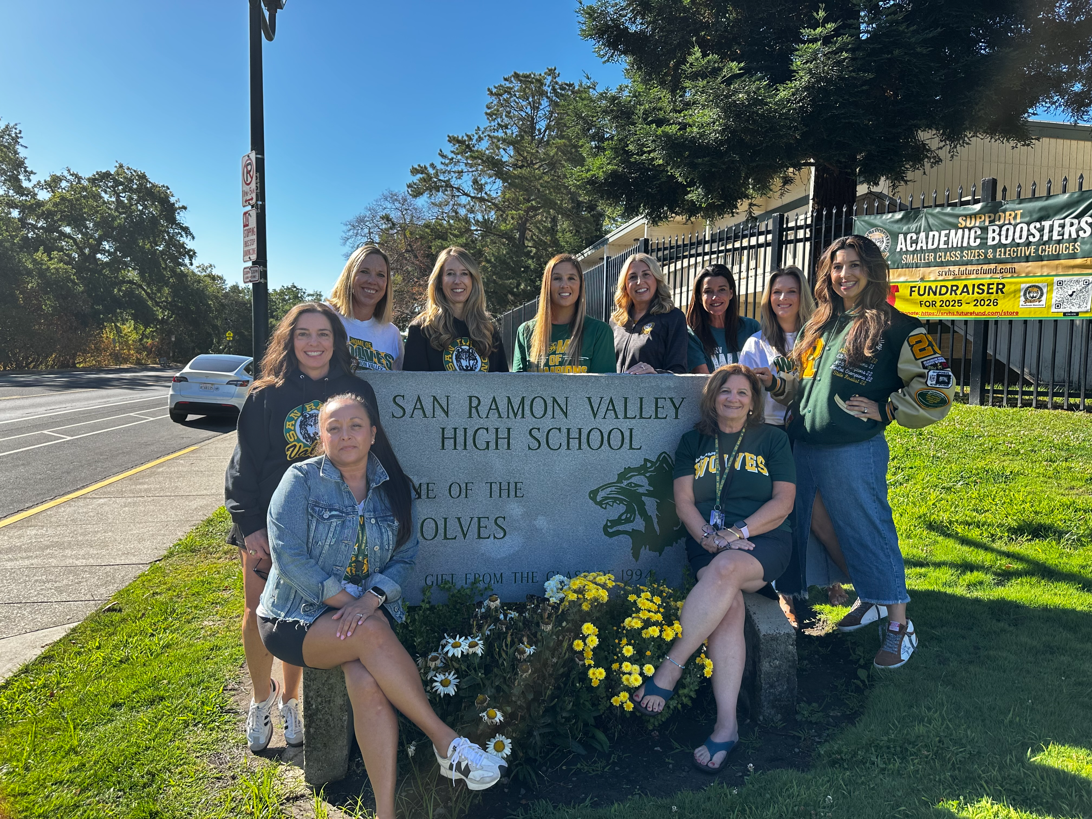 The counseling department posing in front of the school sign along Danville Blvd. 